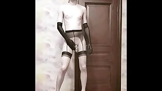 Crossdresser in a cage fucks with a dildo and poses naked